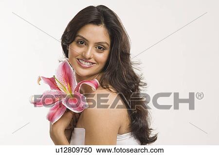 Woman holding a Tiger Lily flower and smiling View Large Photo Image Stock Image - Woman holding a Tiger Lily flower and smiling. Fotosearch