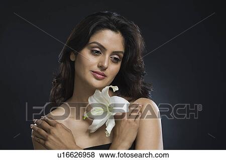 Woman holding a Tiger Lily flower and day dreaming View Large Photo Image Stock Photo - Woman holding a Tiger Lily flower and day dreaming. Fotosearch