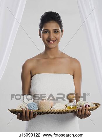 Woman holding a tray of spa products and smiling View Large Photo Image Stock Image - Woman holding a tray of spa products and smiling. Fotosearch