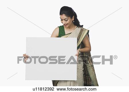 Stock Image - Woman holding a whiteboard and smiling. Fotosearch