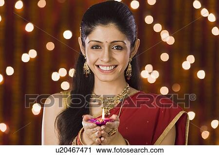 Woman holding an oil lamp and smiling View Large Photo Image Stock Image - Woman holding an oil lamp and smiling. Fotosearch