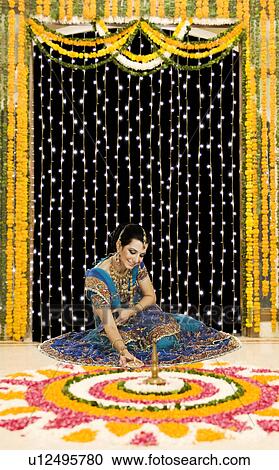Woman holding an oil lamp in Diwali festival View Large Photo Image Stock Image - Woman holding an oil lamp in Diwali festival. Fotosearch