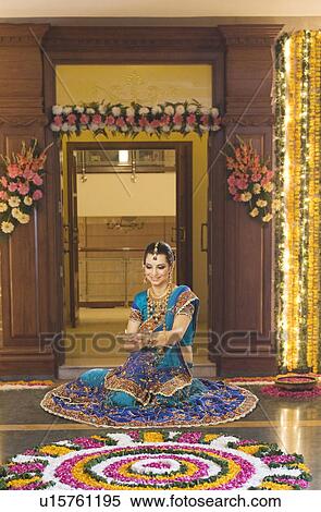 Woman holding an oil lamp in Diwali festival View Large Photo Image Stock Photography - Woman holding an oil lamp in Diwali festival. Fotosearch