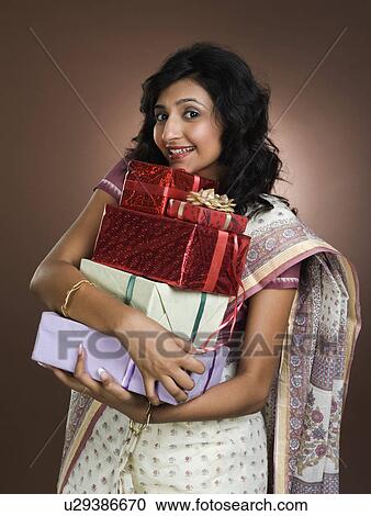 Stock Image - Woman holding gifts. Fotosearch