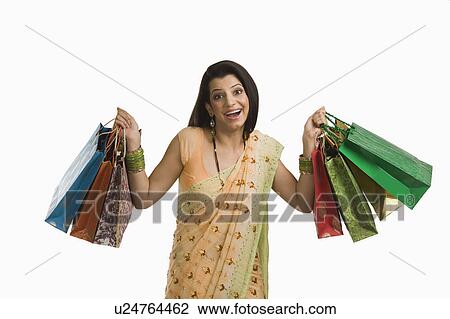 Woman holding shopping bags View Large Photo Image Stock Image - Woman holding shopping bags. Fotosearch