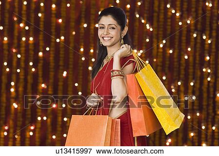 Woman holding shopping bags View Large Photo Image Stock Photo - Woman holding shopping bags. Fotosearch
