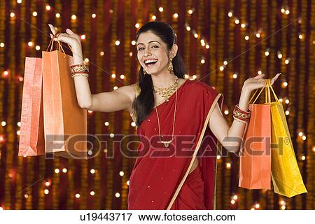 Woman holding shopping bags View Large Photo Image Stock Photo - Woman holding shopping bags. Fotosearch