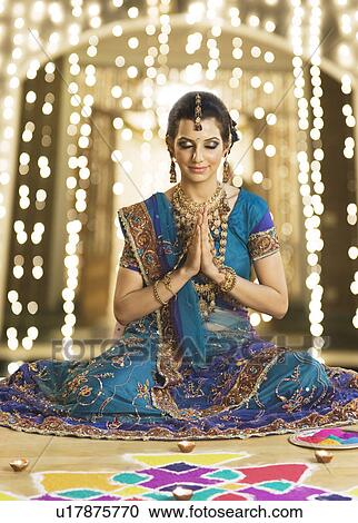 Woman in prayer position near rangoli at Diwali festival View Large Photo Image Stock Image - Woman in prayer position near rangoli at Diwali festival. Fotosearch