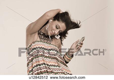 Woman listening to music and dancing View Large Photo Image Stock Image - Woman listening to music and dancing. Fotosearch