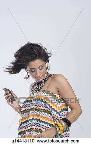 Stock Image - Woman listening to music and dancing. Fotosearch