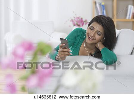 Woman listening to music View Large Photo Image Stock Image - Woman listening to music. Fotosearch