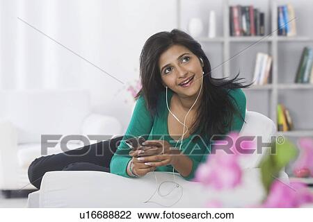 Woman listening to music View Large Photo Image Stock Image - Woman listening to music. Fotosearch