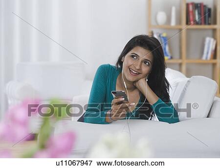 Woman listening to music View Large Photo Image Stock Photo - Woman listening to music. Fotosearch