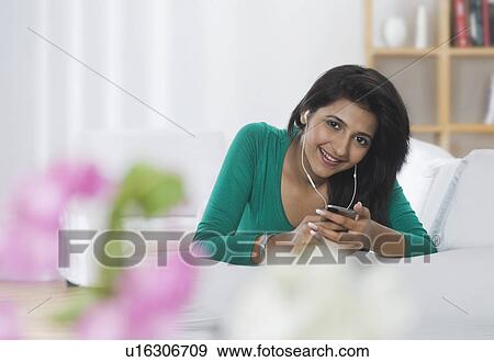 Woman listening to music View Large Photo Image Stock Photo - Woman listening to music. Fotosearch