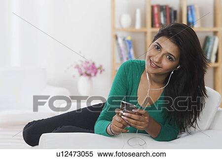 Woman listening to music View Large Photo Image Stock Photography - Woman listening to music. Fotosearch