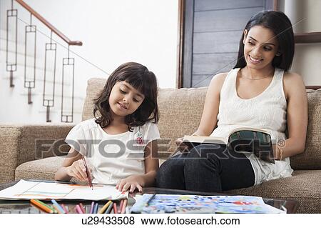 Woman looking at her daughter drawing View Large Photo Image Stock Photo - Woman looking at her daughter drawing. Fotosearch