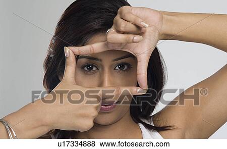 Woman making a finger frame View Large Photo Image Stock Photo - Woman making a finger frame. Fotosearch
