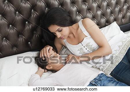 Woman making her daughter sleep View Large Photo Image Stock Image - Woman making her daughter sleep. Fotosearch