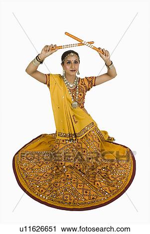Stock Image - Woman performing dandiya. Fotosearch