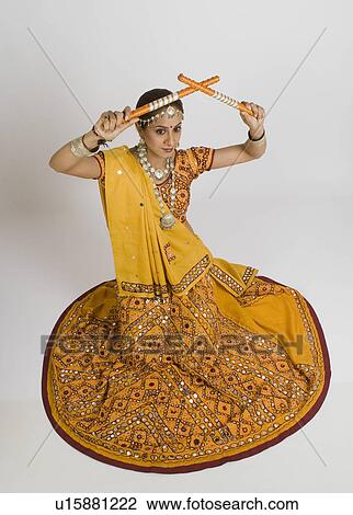 Woman performing dandiya View Large Photo Image Stock Image - Woman performing dandiya. Fotosearch