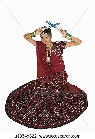 Stock Image - Woman performing dandiya. Fotosearch