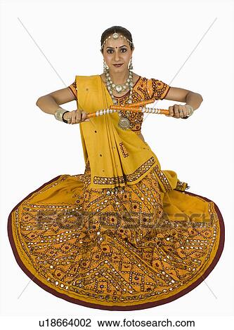 Woman performing dandiya View Large Photo Image Stock Image - Woman performing dandiya. Fotosearch