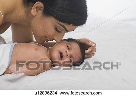 Woman playing with her baby View Large Photo Image Picture - Woman playing with her baby. Fotosearch