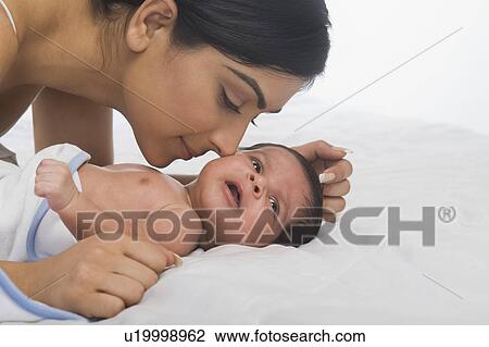 Woman playing with her baby View Large Photo Image Stock Image - Woman playing with her baby. Fotosearch