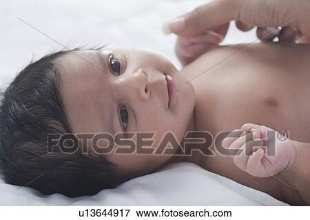 Woman playing with her baby View Large Photo Image Stock Photo - Woman playing with her baby. Fotosearch
