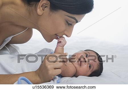 Stock Photo - Woman playing with her baby. Fotosearch