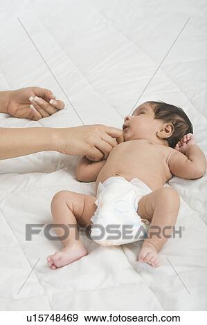 Stock Photo - Woman playing with her baby. Fotosearch