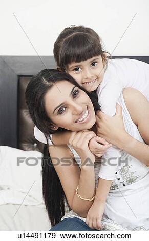 Woman playing with her daughter View Large Photo Image Stock Photo - Woman playing with her daughter. Fotosearch