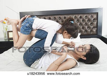 Woman playing with her daughter View Large Photo Image Stock Photograph - Woman playing with her daughter. Fotosearch