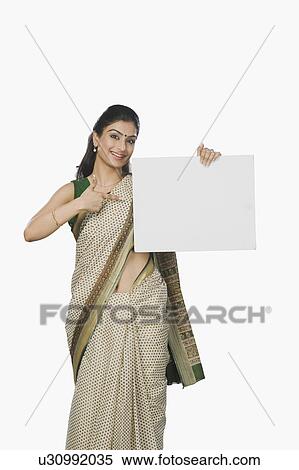 Woman pointing at a whiteboard and smiling View Large Photo Image Stock Photography - Woman pointing at a whiteboard and smiling. Fotosearch