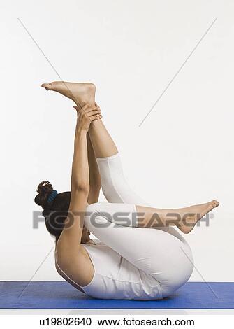 Stock Image - Woman practicing yoga. Fotosearch