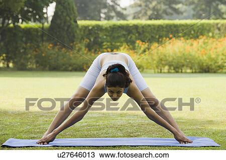 Stock Image - Woman practicing yoga. Fotosearch