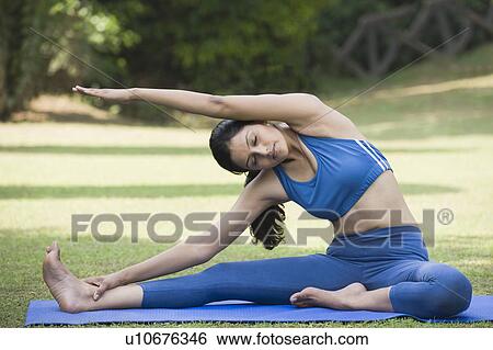 Stock Photograph - Woman practicing yoga. Fotosearch