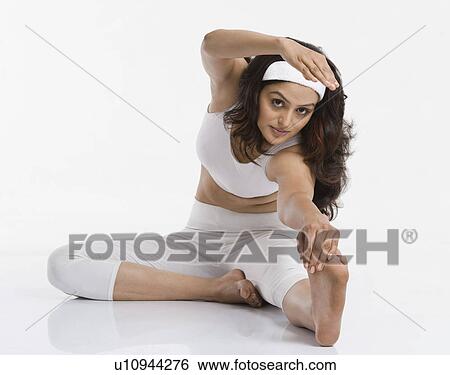 Woman practicing yoga View Large Photo Image Stock Photograph - Woman practicing yoga. Fotosearch