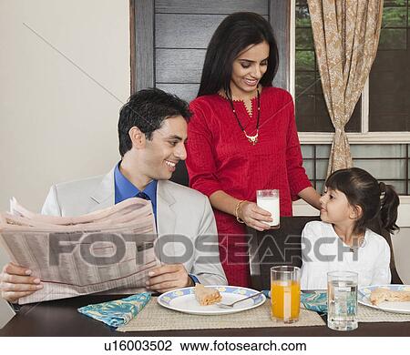 Woman serving breakfast to her family View Large Photo Image Stock Image - Woman serving breakfast to her family. Fotosearch