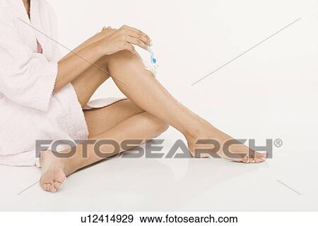 Woman shaving her leg View Large Photo Image Stock Photo - Woman shaving her leg. Fotosearch