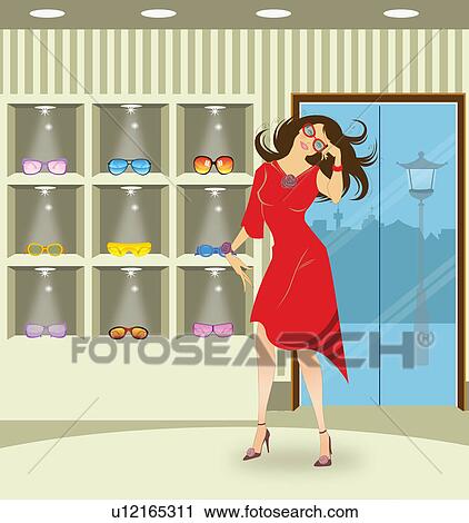 Stock Image - Woman shopping for sunglasses in a store. Fotosearch