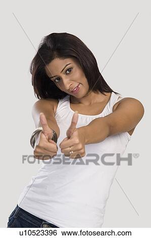 Stock Photograph - Woman showing thumbs up sign. Fotosearch