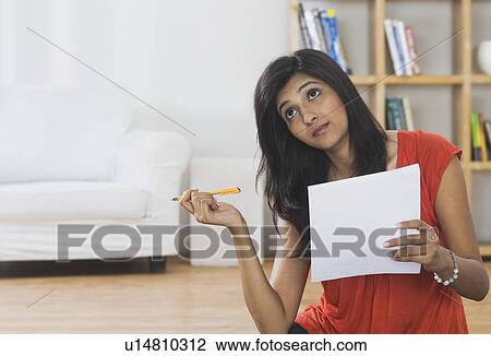 Woman sorting out bills at home View Large Photo Image Stock Image - Woman sorting out bills at home. Fotosearch