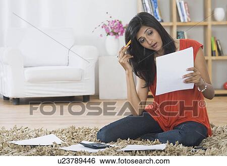 Woman sorting out bills at home View Large Photo Image Stock Photograph - Woman sorting out bills at home. Fotosearch