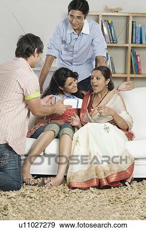 Stock Photo - Woman surprise to look a gift. Fotosearch