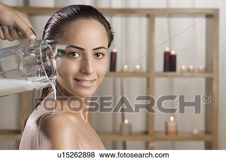 Stock Photo - Woman taking a milk bath in a health spa. Fotosearch
