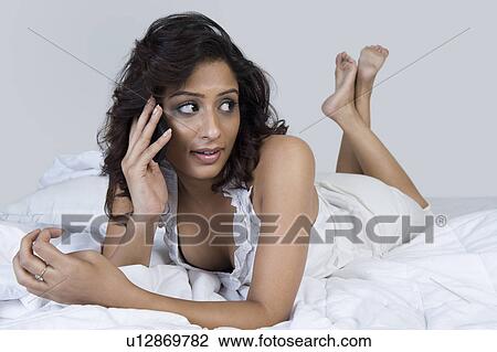 Stock Image - Woman talking on a mobile phone. Fotosearch