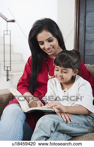 Woman teaching her daughter View Large Photo Image Stock Image - Woman teaching her daughter. Fotosearch