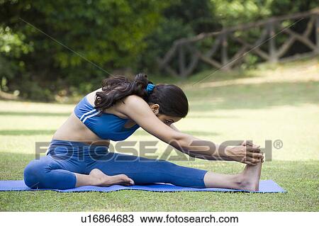 Stock Image - Woman touching her toes. Fotosearch