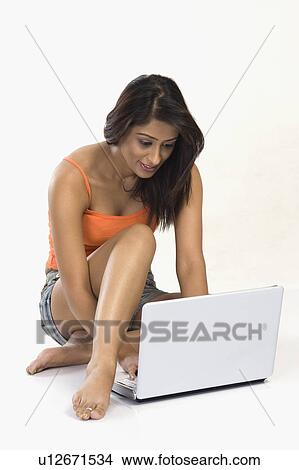Picture - Woman using a laptop. Fotosearch